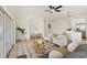 Open living area features wood-look flooring, neutral furniture, and sliding glass doors to the backyard at 2814 Graphite Ct, Valrico, FL 33594