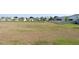 Spacious backyard surrounded by neighborhood homes, offering ample outdoor space at 2880 Gumbo Limbo Dr, Wimauma, FL 33598