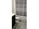 Bright bathroom featuring gray and white striped shower curtain, tile flooring, and toilet at 2880 Gumbo Limbo Dr, Wimauma, FL 33598