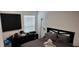 Cozy bedroom showcasing a bed, dresser, and a window with blinds at 2880 Gumbo Limbo Dr, Wimauma, FL 33598