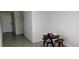 Dining area with tiled flooring and a round wood table with three chairs at 2880 Gumbo Limbo Dr, Wimauma, FL 33598