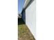 Side exterior of the house showing the wall and the green grass at 2880 Gumbo Limbo Dr, Wimauma, FL 33598