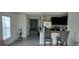 Open-concept space features a kitchen with a breakfast bar and seating at 2880 Gumbo Limbo Dr, Wimauma, FL 33598