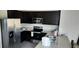 Well-equipped kitchen featuring stainless steel appliances and dark wood cabinets for a modern touch at 2880 Gumbo Limbo Dr, Wimauma, FL 33598