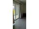 Bright living room featuring neutral tones, tile flooring, and sliding glass doors to lanai at 2880 Gumbo Limbo Dr, Wimauma, FL 33598