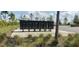 A view of the community mailboxes with green landscaping and a parking area at 2880 Gumbo Limbo Dr, Wimauma, FL 33598