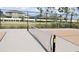 Well-maintained community pickleball court with a net and manicured landscaping at 2880 Gumbo Limbo Dr, Wimauma, FL 33598