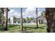 Beautiful community pool with cabana, palm trees, and manicured green space at 2880 Gumbo Limbo Dr, Wimauma, FL 33598