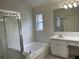 Bathroom with a separate shower, tub, and single sink vanity with window at 29228 Yarrow Dr, Wesley Chapel, FL 33543