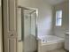 Bathroom with large tub, shower and window providing natural light at 29228 Yarrow Dr, Wesley Chapel, FL 33543