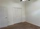 Bedroom with carpet flooring, a ceiling fan, and closet with white doors at 29228 Yarrow Dr, Wesley Chapel, FL 33543