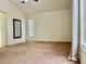 Bedroom featuring neutral walls, carpeted floors, a large mirror and a window with blinds at 29228 Yarrow Dr, Wesley Chapel, FL 33543