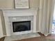 Close up of a fireplace with a modern tile surround and decorative mantle in a living room at 29228 Yarrow Dr, Wesley Chapel, FL 33543
