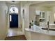 Foyer showcasing a blue front door, tile flooring, and views to the kitchen at 29228 Yarrow Dr, Wesley Chapel, FL 33543