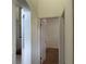 Hallway view into bedroom with neutral paint and brown carpet at 29228 Yarrow Dr, Wesley Chapel, FL 33543