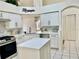 Bright, spacious kitchen with white cabinets, island, stone backsplash, and stainless steel appliances at 29228 Yarrow Dr, Wesley Chapel, FL 33543