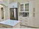 Modern kitchen with stainless steel appliances, island with quartz countertop, and white cabinets at 29228 Yarrow Dr, Wesley Chapel, FL 33543