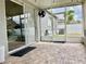 Tiled patio with fan, sliding glass doors, and access to the backyard at 29228 Yarrow Dr, Wesley Chapel, FL 33543