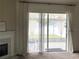 View of patio with string lights, furniture and curtains from inside the living room at 29228 Yarrow Dr, Wesley Chapel, FL 33543