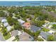 Aerial view of a residential neighborhood with lush vegetation, houses, and a view of the bay at 315 Ridge Rd, Palm Harbor, FL 34683