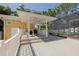 Backyard deck featuring a covered outdoor area with seating and a screened in hot tub at 315 Ridge Rd, Palm Harbor, FL 34683
