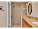 Shower room showcasing a glass door, tiled walls, and a vanity with granite top with double sinks at 315 Ridge Rd, Palm Harbor, FL 34683