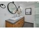 Elegant bathroom featuring double sinks, round mirrors, and modern fixtures set on top of wood cabinets at 315 Ridge Rd, Palm Harbor, FL 34683