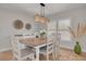 Bright dining room with a rustic wood table, white chairs, and plantation shutters for natural light at 315 Ridge Rd, Palm Harbor, FL 34683