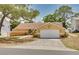 Inviting single-story home featuring a clay tile roof and a two-car garage with a lovely, landscaped front yard at 315 Ridge Rd, Palm Harbor, FL 34683