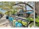 Outdoor seating area in front of Ozona Brewing Company with colorful bar stools and lush green landscape at 315 Ridge Rd, Palm Harbor, FL 34683