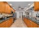 Well-lit kitchen featuring granite countertops, modern appliances, and ample cabinet space at 315 Ridge Rd, Palm Harbor, FL 34683