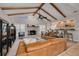 Spacious living room featuring exposed beams, stone fireplace, and modern furniture at 315 Ridge Rd, Palm Harbor, FL 34683