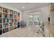 Bright office space with a bookcase and a sliding door leading to an outdoor area at 315 Ridge Rd, Palm Harbor, FL 34683