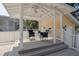 Charming covered outdoor patio with ceiling fan and comfortable seating area at 315 Ridge Rd, Palm Harbor, FL 34683