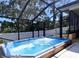 Relaxing screened outdoor pool area with a beautiful white fence and mature trees at 315 Ridge Rd, Palm Harbor, FL 34683