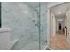 Beautiful bathroom showcasing a marble tiled shower with a glass door, bench seating and a sleek showerhead at 315 Ridge Rd, Palm Harbor, FL 34683