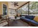 Comfortable sunroom with ample seating and view of the backyard pool and gazebo at 315 Ridge Rd, Palm Harbor, FL 34683