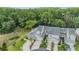 Aerial view of townhomes showcasing their layout, landscaping, and surrounding trees at 3205 Audubon Ct, Tarpon Springs, FL 34688