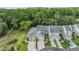 Aerial view of townhomes with garages, lush landscaping, and backing to a nature preserve at 3205 Audubon Ct, Tarpon Springs, FL 34688
