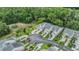 Aerial view of townhomes with garages, lush landscaping, and convenient parking at 3205 Audubon Ct, Tarpon Springs, FL 34688