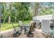 Backyard patio featuring outdoor seating and a grill, perfect for entertaining guests at 3205 Audubon Ct, Tarpon Springs, FL 34688