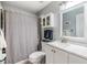 Bathroom featuring white vanity with solid surface counter and gray shower curtain at 3205 Audubon Ct, Tarpon Springs, FL 34688