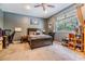 Bedroom featuring a window, wood furniture, and neutral walls and carpet at 3205 Audubon Ct, Tarpon Springs, FL 34688