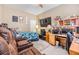 Bedroom featuring a workspace with multiple monitors, a recliner, and a floral-print bedspread at 3205 Audubon Ct, Tarpon Springs, FL 34688