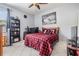 Bedroom featuring tile floors, red plaid bedspread, and dark curtains at 3205 Audubon Ct, Tarpon Springs, FL 34688