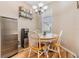Cozy dining nook featuring a chandelier, window with blinds, and a table set for four, located off the kitchen at 3205 Audubon Ct, Tarpon Springs, FL 34688
