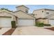 Charming two-story townhome with attached garage and well-maintained landscaping at 3205 Audubon Ct, Tarpon Springs, FL 34688