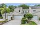 Charming townhome with lush landscaping, mature palm trees and attached two-car garage at 3205 Audubon Ct, Tarpon Springs, FL 34688