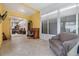 Bright sunroom with tile flooring, an inviting chair, and an office desk space at 3205 Audubon Ct, Tarpon Springs, FL 34688