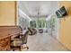 Bright sunroom featuring tile floors, a fan, and lots of natural light at 3205 Audubon Ct, Tarpon Springs, FL 34688